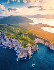 View from flying drone. Coloful sunrise on Caccia cape. Awesome spring scene of Sardinia island,...