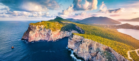 Panotamic view from flying drone. Great sunrise on Caccia cape. Breathtaking spring scene of Sardinia island, Italy, Europe. Fantastic morning seascape of Mediterranean sea. 