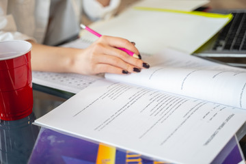 Cropped photo of woman working with papers and laptop