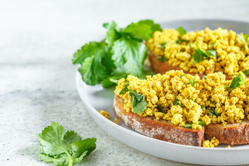 Tofu scramble sandwich on a gray plate. Vegan food concept.