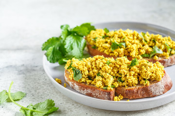 Tofu scramble sandwich on a gray plate. Vegan food concept.