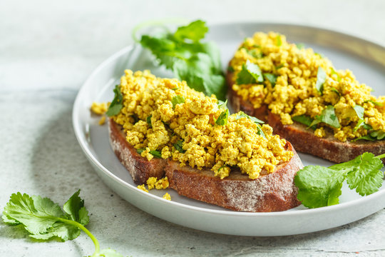 Tofu scramble sandwich on a gray plate. Vegan food concept.
