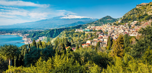 View from flying drone. Amazing morning view of Taormina town and Etna volcano on background. Astonishing spring seascape of Mediterranean sea. Splendid view of Sicily, Italy, Europe.