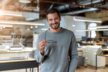 Dont be a dull and boring one. Young businessman posing in office