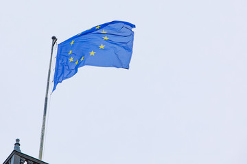 european union flag in front of blue sky