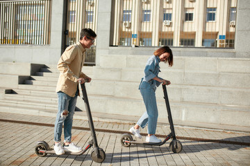 Enjoy your ride. Two friends having fun driving electric scooters on a sunny day © Svitlana