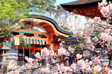 Ancient pavilion and blooming sakura in Fushimi Inari shrine, Kyoto, Japan