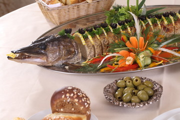 Table served with stuffed pike, vodka, moonshine in a restaurant