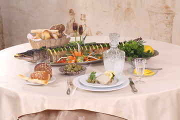 Table served with stuffed pike, vodka, moonshine in a restaurant