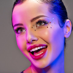 Portrait of happy girl. Laughing face of a beautiful model. Colorful portrait of a girl with bright...