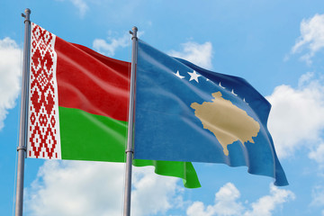 Kosovo and Belarus flags waving in the wind against white cloudy blue sky together. Diplomacy concept, international relations.