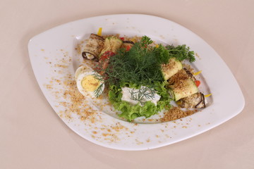 Eggplant rolls with spicy filling, herbs and eggs with nut dressing