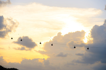 silhouette of singapore cable car transportation to sentosa island on the evening