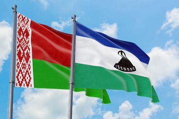 Lesotho and Belarus flags waving in the wind against white cloudy blue sky together. Diplomacy concept, international relations.