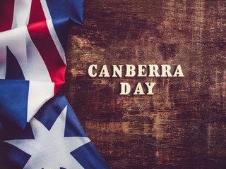 Fototapeta na wymiar Wooden letters of the alphabet in the form of the words CANBERRA DAY lying on the table. Beautiful card. Isolated background, wooden surface. Congratulations for relatives, friends and colleagues
