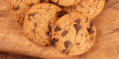 Chocolate chip cookies panorama on a rustic wooden background