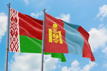 Mongolia and Belarus flags waving in the wind against white cloudy blue sky together. Diplomacy concept, international relations.