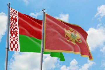 Montenegro and Belarus flags waving in the wind against white cloudy blue sky together. Diplomacy concept, international relations.