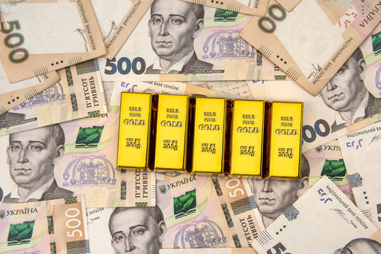 stacks of gold bars on ukraine moneu uah . top view