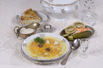 chicken soup with vermicelli, a glass of vodka and pickles