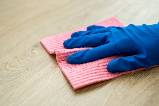 woman doing kitchen cleaning chores with rubber gloves and rag. cleaning concept.
