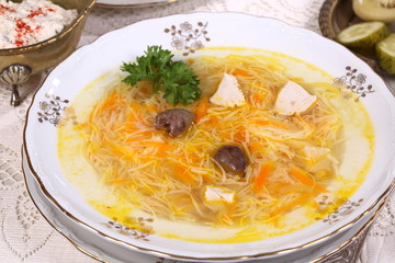 chicken soup with vermicelli, a glass of vodka and pickles