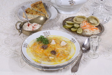 chicken soup with vermicelli, a glass of vodka and pickles