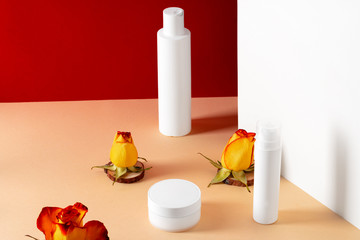 Cosmetic bottles with rose petals, copy space