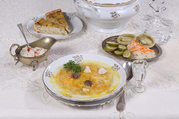 chicken soup with vermicelli, a glass of vodka and pickles