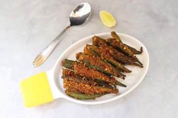 Indian stuffed masala bhindi or Okra or Ladyfinger. Served with lemon wedge. Fried Bhindi is perfect lunch or dinner dish. Copy space.