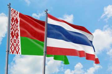 Thailand and Belarus flags waving in the wind against white cloudy blue sky together. Diplomacy concept, international relations.