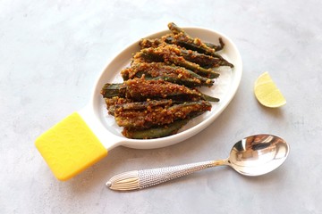 Indian stuffed masala bhindi or Okra or Ladyfinger. Served with lemon wedge. Fried Bhindi is perfect lunch or dinner dish. Copy space.