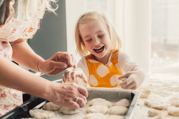 Mom cooking with daughter on the kitchen