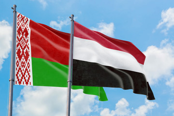 Yemen and Belarus flags waving in the wind against white cloudy blue sky together. Diplomacy concept, international relations.