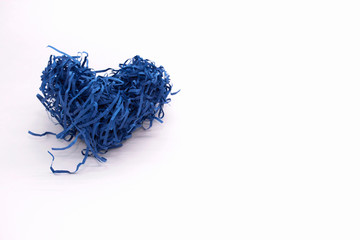 Paper heart of indigo color made of shredded paper for postcards and congratulations on a light...