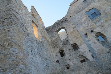 Ancient ruined European castle with several empty windows 