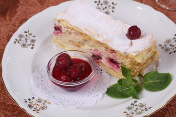 Tea with jam and cake from puff pastry with cherry
