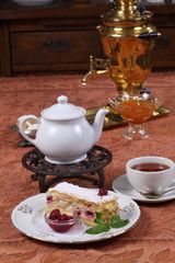 Tea with jam and cake from puff pastry with cherry