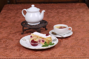 Tea with jam and cake from puff pastry with cherry