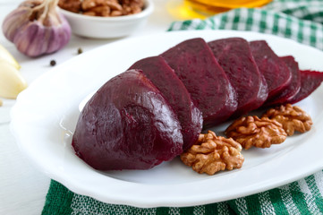 Slices of boiled beets on a white plate. Source of energy. Dietary healthy vegetable.