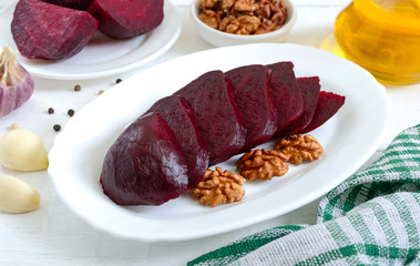 Slices of boiled beets on a white plate. Source of energy. Dietary healthy vegetable.