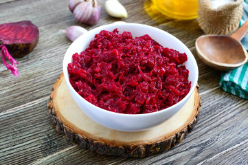 Beetroot caviar. Simple, tasty and healthy vegetable snack in a white bowl on a wooden table....