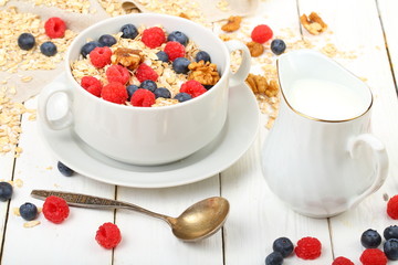 Muesli with milk and apple on a white background