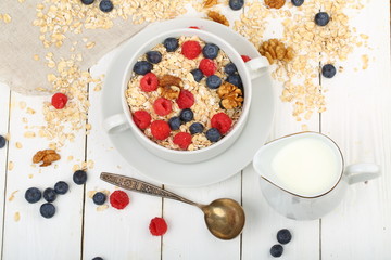 Muesli with milk and apple on a white background