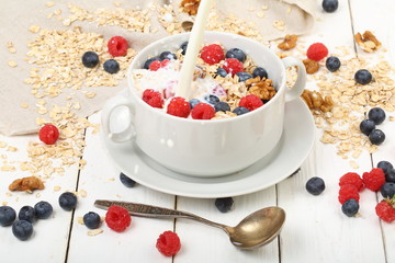 Muesli with milk and apple on a white background