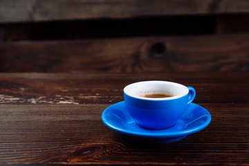 Dirty cup after coffee on a wooden table.