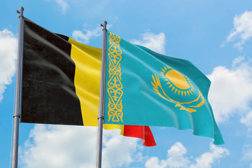 Kazakhstan and Belgium flags waving in the wind against white cloudy blue sky together. Diplomacy concept, international relations.