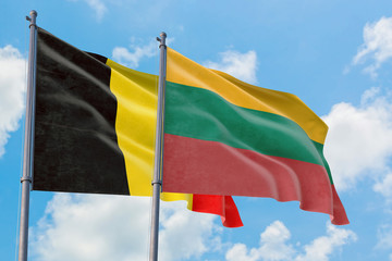 Lithuania and Belgium flags waving in the wind against white cloudy blue sky together. Diplomacy concept, international relations.