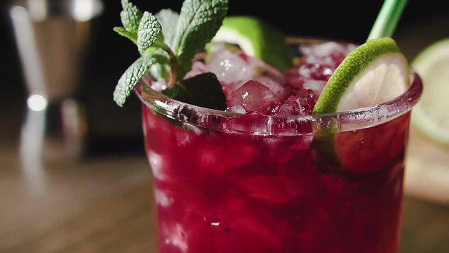 Cocktail with lime, mint and ice, cran shot, close up.