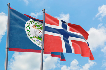 Bouvet Islands and Belize flags waving in the wind against white cloudy blue sky together....